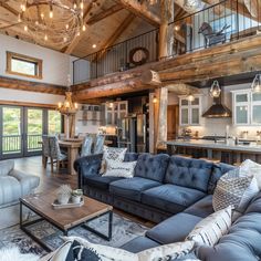 a living room filled with furniture next to a kitchen and an open concept floor plan