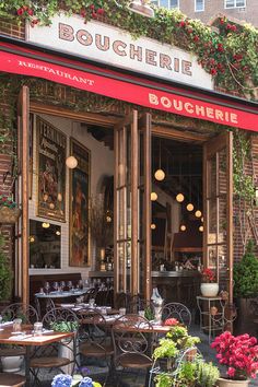 the outside of a restaurant with tables and chairs