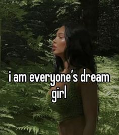 a woman standing in the woods with text that reads, i am everyone's dream girl