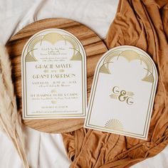 the wedding stationery is laid out next to each other on top of a bed