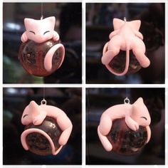 four pictures of pink cat ornaments hanging from strings