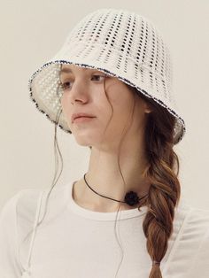 a woman wearing a white hat with braids