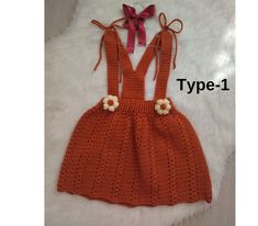 an orange crocheted dress with flowers on the front and back, is shown