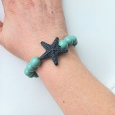 Elevate your summer style with this beautifully handmade starfish stretch bracelet part of the Crazy Summer collection by Karmalizia. This original accessory effortlessly stretches for a comfortable fit, while adding a touch of sophistication to any outfit. Perfect for a day at the beach or a night out, this bracelet is a must-have for the season. MATERIALS: Resin, ceramic Jade Green, Starfish, Stretch Bracelets, Summer Collection, Night Out, Comfort Fit, Summer Fashion, Ceramics, Black