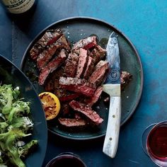 steak, salad and wine on a table