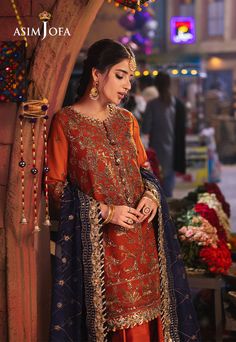 Brand: Asim JofaProduct Code: AJKK-10Collection: Chamkeeli by Asim Jofa Unstitched Festive CollectionFabric: Chiffon PRODUCT DETAILS: Capture the fading embers of a sunset in this shimmering rust ensemble, reminiscent of the last rays of the sun. The gorgeous shirt, a canvas woven with firelight, boasts an all-over embroidered pattern, with antique gold and two-toned zari shimmering like molten metal, beautifully accented with navy-blue threads that whisper of the twilight sky. Gold sequins glisten with the final flicker of the sun's brilliance, peeking through a tinted glass. The meticulously embroidered dupatta, in a navy-blue shade, complements the ensemble like the cool embrace of evening. DESIGN DETAILS: Embroidered front neckline on chiffon 30'' embroidered jaal for front on chiffon Molten Metal, Asim Jofa, Twilight Sky, Rays Of The Sun, Tinted Glass, Embroidered Chiffon, Embroidered Dupatta, Gold Sequins, Fabric Stores Online