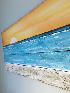 an orange and blue painting hanging on the wall