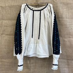 Beautiful handmade 1970s traditional folk Romanian blouse with black embroidery mostly on the sleeve. made in the Nadăș community in Arad , Romania hemp and cotton mix Size S Each item is special and unique so may come with some beautiful little imperfections : ) Message me if you have any questions xx Folk Style Tops For Fall Festival, Long Sleeve Cotton Tops With Traditional Patterns, Festival Cotton Peasant Top With Geometric Embroidery, Traditional Long Sleeve Peasant Top With Geometric Embroidery, Peasant Style Long Sleeve Embroidered Top, Fall Embroidered Sleeves Peasant Top, Fall Peasant Top With Embroidered Sleeves, Spring Folk Blouse With Woven Motifs, Black Folk Style Peasant Top