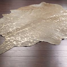 a cowhide rug on a wooden floor