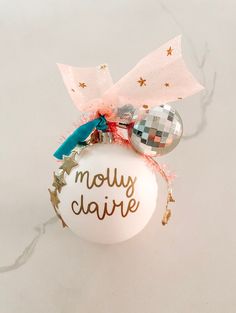 a glass ornament that says moly claire on it