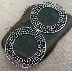 Here are some unique, chic and fun big circle earrings.  They are simple yet refined.  They have a cool textured design which gives them a rustic modern look.  Versatile and perfect for everyday wear.The earrings measure 1 7/8” long by 1 7/8” wide.  They hang from simple silver ear wire hooks.  Overall drop length is 2”.  Made from allergy free plated silver.I have a matching necklace in my shop if you would like the whole set.  Here is a direct link............. https://etsy.me/3cg1X6cThanks fo Big Circle Earrings, Hoop Earrings Large, Ocean Earrings, Geometric Hoop Earrings, Round Dangle Earrings, Statement Hoop Earrings, Earrings Big, Hammered Earrings, Big Hoop Earrings