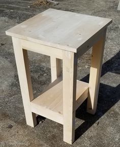 a small wooden table sitting on the ground