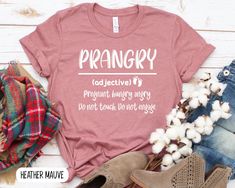 a t - shirt with the words prangry on it next to some cotton