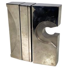 a pair of silver metal bookends sitting on top of each other