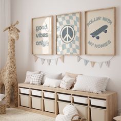 a child's room decorated in white and blue with pictures on the wall, stuffed giraffe