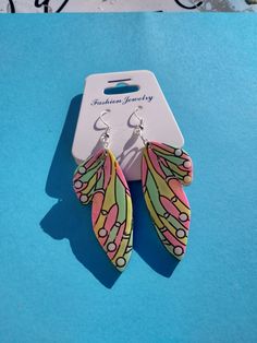 A beautiful unique set of butterfly wing earrings 🦋 made with Pastel green pink and yellow pigments with black backs sealed in a clear coat of UV Resin 🖤💚💛🖤 we also do custom creations feel free to message me anytime for more information 😀 Butterfly Wing Earrings Ohmybutterfly, Butterfly Wings Earrings, Resin Butterfly Wing Earrings, Multicolor Butterfly Charm Earrings, Wings Earrings, Butterfly Wing Earrings, Pastel Roses, Butterfly Wing, Wing Earrings