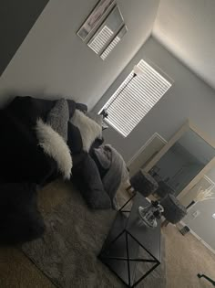 a living room filled with furniture and pillows