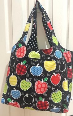 It's time to ditch plastic bags and upgrade to a reusable tote bag made from 100% lightweight cotton fabric and which features a zippered pocket.  The black fabric depicts a chalk board with colorful apples and white alphabet.  The lining is a coordinating black with white polka dots fabric.  The bag is reversible.  The lining also features a patch type pocket, handy for cell-phone, lists, coupons or what ever you need to stash in there while shopping.  There are numerous uses for this bag, bring it shopping or to the farmers market, to the pool or beach, library or school.  It is very sturdy and roomy and is machine washable and dry able on medium heat.  I included some pictures of similar bags to show the size and versatility.  This listing only includes the apple chalk board print bag b Back To School Black Cotton Bag, Black Cotton Bag For Back To School, Black Cotton Bags For Back To School, Polka Dot Fabric, Plastic Bags, Printed Bags, White Polka Dot, Black Fabric, Plastic Bag