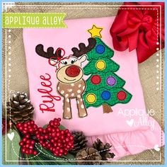 an applique christmas tree and reindeer on a pink shirt