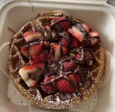 a waffle topped with strawberries and chocolate