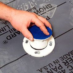 a person is using a blue button to push something on the ground