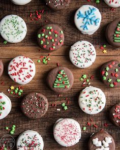 many decorated cookies on a wooden table