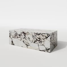 a white and black marble box sitting on top of a table