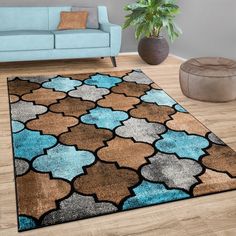 a living room with a blue couch and brown rug