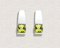 "Peridot Earrings - Argentium Silver - 2431 A contemporary, yet timeless design by award winning designer, David Worcester. Cast in Argentium 960 premium quality 100% recycled silver, these earrings are specially processed for tension setting. They measure 18mm x 7mm (3/4 x 1/4\") inches, and hold six millimeter antique square checkerboard cut Peridot. PLEASE LOOK AT THE MEASUREMENTS CAREFULLY. SOME PHOTOS HAVE BEEN ENLARGED TO SHOW DETAIL, WHILE OTHERS HAVE BEEN MINIMIZED TO FIT THE FRAME. ACTU Modern Green Earrings, Modern Peridot Jewelry For Formal Occasions, Modern Green Peridot Jewelry, Green Modern Sterling Silver Earrings, Modern Green Sterling Silver Earrings, Modern White Gold Earrings With Tension Setting, Modern Green Earrings With Polished Finish, Modern Peridot Jewelry As A Gift, Modern Peridot Jewelry For Gift