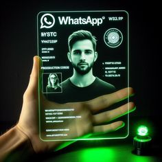 a person holding up a green glowing id card with the image of a man's face on it