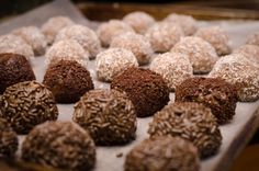 chocolate truffles are lined up on a baking sheet and ready to be eaten