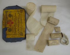 an old book, tape, and other items are laid out on a white surface