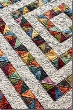 a colorful quilt with many different colors on it