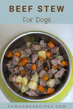 beef stew with carrots, potatoes and celery in a green bowl on a white table