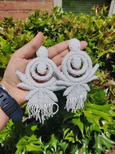 White Beaded Earrings Handmade White beaded embroidered Statement Earrings These earrings are purely handmade and hand-embroidered oversize earrings. These are beautiful and look pretty on anybody. It has an irregular pattern with embroidered beads work. This can be used for wedding and bridal wear or as casual.  Earrings measure about approx. 5 inches long  Product Weight: 2 oz Color: White Material: Beads and Felt The earrings are heavy and may not be for all; please choose wisely.  I'll proce Elegant Beaded Danglers For Party, Elegant Beaded Danglers For Celebration, Bohemian Beaded Dangle Earrings For Wedding, White Earrings With Dangling Beads For Celebration, Silver Dangling Beads Earrings For Celebration, Festive White Beaded Earrings With Dangling Beads, Traditional White Beaded Earrings For Celebration, Bohemian Beaded Bridal Earrings, Festive White Dangling Beaded Earrings