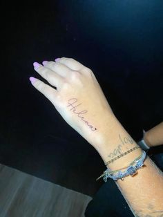 a woman's hand with the word hope tattooed on her left arm and wrist