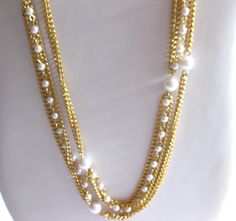 Extra long gold tone chain link and white pearl necklace, 54" long with 2 1/2" adjustable chain.  In good clean vintage condition. FREE SHIPPING IN THE USA ONLY. Gold Long Necklace With Pearl Chain For Formal Events, Gold Long Necklace With Pearl Chain For Formal Occasions, White Multi-strand Double Chain Necklace, White Pearl Double Chain Necklace, Pearl Gold Necklace, White Pearl Necklace, Gold Pearl Necklace, White Pearl, Pearl White