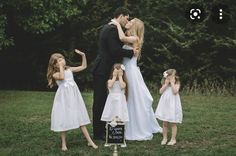 a bride and groom kissing with their children