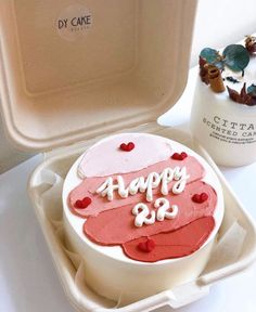 a birthday cake in a foam container on a table