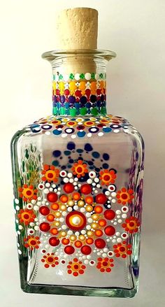 a glass bottle with colorful designs on it