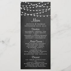 a chalkboard menu with string lights on it