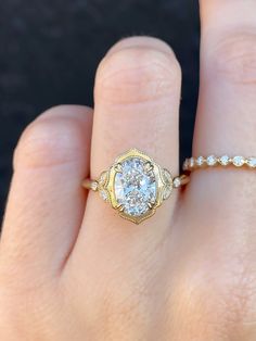 a woman's hand with a yellow gold ring and diamond band on her finger