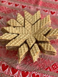 some waffles are on a glass plate and have been cut into small snowflakes