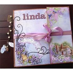 a handmade greeting card with flowers and a ribbon tied around the edges that says linda