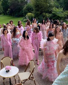 a group of women dressed in pink dresses