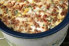 a casserole dish with meat, cheese and vegetables in it sitting on a table