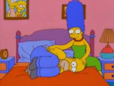 the simpsons is sitting in bed with his feet up on another person's head