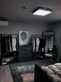 a bedroom with a bed, dresser and mirror