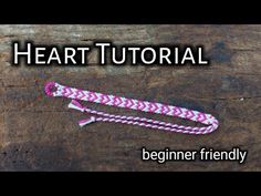 a pink and white rope on top of a wooden table with the words heart tutor