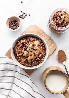 a bowl of chocolate chip baked oatmeal next to a cup of coffee